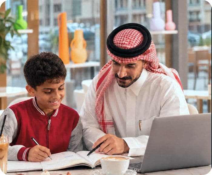 A tutor guiding a student through a lesson at a laptop